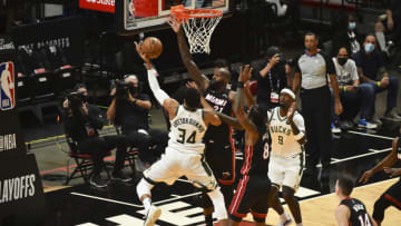 Giannis Antetokounmpo #34 of the Milwaukee Bucks attempts a shot while being defended by Dewayne Dedmon #21 of the Miami Heat(Photo by Eric Espada/Getty Images)