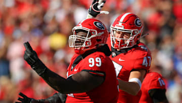 ATHENS, GA - OCTOBER 16: Jordan Davis #99 reacts with Dan Jackson #47 of the Georgia Bulldogs after a stop in the first half against the Kentucky Wildcats at Sanford Stadium on October 16, 2021 in Athens, Georgia. (Photo by Todd Kirkland/Getty Images)