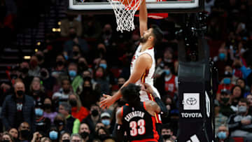 Omer Yurtseven # 77 of the Miami Heat dunks the ball past Robert Covington # 33 of the Portland Trail Blazers(Photo by Soobum Im/Getty Images)