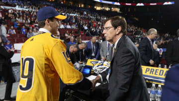 VANCOUVER, BRITISH COLUMBIA - JUNE 22: Egor Afanasyev, 45th overall pick of the Nashville Predators, is greeted at the draft table by general manager David Poile a the team draft table during Rounds 2-7 of the 2019 NHL Draft at Rogers Arena on June 22, 2019 in Vancouver, Canada. (Photo by Dave Sandford/NHLI via Getty Images)