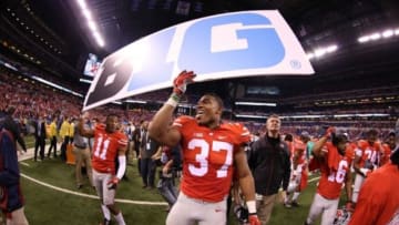 Dec 6, 2014; Indianapolis, IN, USA; Ohio State Buckeyes safety Vonn Bell (11) and linebacker Joshua Perry (37) hold up a Big 10 sign after defeating the Wisconsin Badgers in the Big Ten Football Championship game at Lucas Oil Stadium. Ohio State defeats Wisconsin 59-0. Mandatory Credit: Brian Spurlock-USA TODAY Sports