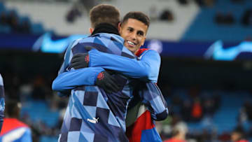 MANCHESTER, ENGLAND - APRIL 11: Joao Cancelo of Bayern Munich embraces Aymeric Laporte of Manchester City prior to the UEFA Champions League quarterfinal first leg match between Manchester City and FC Bayern München at Etihad Stadium on April 11, 2023 in Manchester, England. (Photo by James Gill - Danehouse/Getty Images)