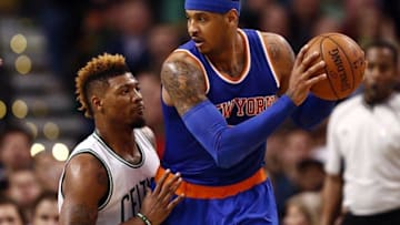 Mar 4, 2016; Boston, MA, USA; New York Knicks forward Carmelo Anthony (right) holds the ball as Boston Celtics guard Marcus Smart (left) defends during the second half at TD Garden. Mandatory Credit: Mark L. Baer-USA TODAY Sports