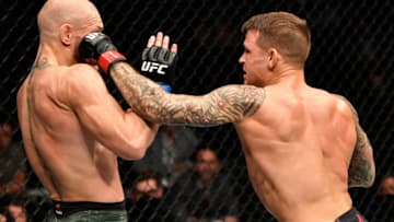 ABU DHABI, UNITED ARAB EMIRATES - JANUARY 23: In this handout image provided by the UFC, (R-L) Dustin Poirier punches Conor McGregor of Ireland in a lightweight fight during the UFC 257 event inside Etihad Arena on UFC Fight Island on January 23, 2021 in Abu Dhabi, United Arab Emirates. (Photo by Jeff Bottari/Zuffa LLC via Getty Images)