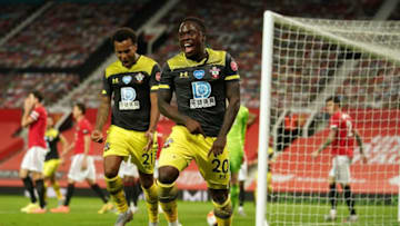 Southampton's Irish-born striker Michael Obafemi (C) celebrates after scoring their late second goal during the English Premier League football match between Manchester United and Southampton at Old Trafford in Manchester, north-west England, on July 13, 2020. - The game finished 2-2. (Photo by Dave Thompson / POOL / AFP) / RESTRICTED TO EDITORIAL USE. No use with unauthorized audio, video, data, fixture lists, club/league logos or 'live' services. Online in-match use limited to 120 images. An additional 40 images may be used in extra time. No video emulation. Social media in-match use limited to 120 images. An additional 40 images may be used in extra time. No use in betting publications, games or single club/league/player publications. / (Photo by DAVE THOMPSON/POOL/AFP via Getty Images)