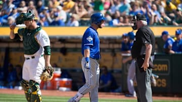Apr 17, 2016; Oakland, CA, USA; Kansas City Royals left fielder Alex Gordon (4) argues with home plate umpire Brian Gorman (9) after striking out against Oakland Athletics catcher Stephen Vogt (21) during the ninth inning at the Oakland Coliseum. The Athletics won 3-2. Mandatory Credit: Kelley L Cox-USA TODAY Sports