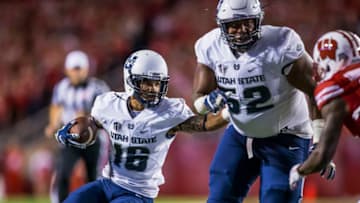MADISON, WI - SEPTEMBER 01: Utah State Aggies wide receiver Jordan Nathan (16) tries to direct Utah State Aggies offensive lineman Sean Taylor (52) to gain more yards durning an college football game between the Utah State Aggies and the Wisconsin Badgers on September 1st, 2017, at Camp Randall Stadium in Madison, WI. Wisconsin defated Utah State 59-10. (Photo by Dan Sanger/Icon Sportswire via Getty Images)
