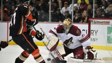 November 23, 2014; Anaheim, CA, USA; Arizona Coyotes goalie Mike Smith (41) blocks a shot against Anaheim Ducks defenseman Hampus Lindholm (47) during the second period at Honda Center. Mandatory Credit: Gary A. Vasquez-USA TODAY Sports