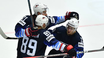 Dylan Larkin (L) Cam Atkinson (front) and Johnny Gaudreau of the United States celebrate the winning goal of the group B match USA vs Latvia of the 2018 IIHF Ice Hockey World Championship at the Jyske Bank Boxen in Herning, Denmark, on May 10, 2018. (Photo by JOE KLAMAR / AFP) (Photo credit should read JOE KLAMAR/AFP/Getty Images)