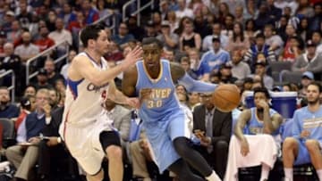 Apr 15, 2014; Los Angeles, CA, USA; Denver Nuggets forward Quincy Miller (30) drives against Los Angeles Clippers guard J.J. Redick (4) during the first half at Staples Center. Mandatory Credit: Richard Mackson-USA TODAY Sports