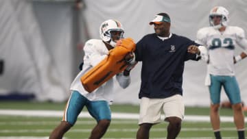 Auburn footballDAVIE, FL - AUGUST 30: Roberto Wallace #18 works with assistant wide Receivers coach Ike Hilliard of the Miami Dolphins during training camp on August 30, 2011 at the Miami Dolphins training facility in Davie, Florida. (Photo by Joel Auerbach/Getty Images)