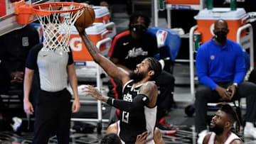 May 9, 2021; Los Angeles, California, USA; LA Clippers guard Paul George (13) flies to the basket between New York Knicks center Nerlens Noel (3), guard Derrick Rose (4) and forward Reggie Bullock (25) during the second quarter at Staples Center. Mandatory Credit: Robert Hanashiro-USA TODAY Sports