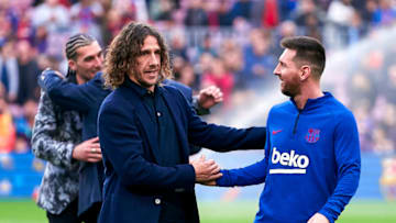 Lionel Messi of FC Barcelona and ex former player of FC Barcelona Carles Puyol. (Photo by Quality Sport Images/Getty Images)