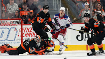 PHILADELPHIA, PA - MARCH 31: Carter Hart #79, Travis Sanheim #6, and Nolan Patrick #19 of the Philadelphia Flyers, and as Lias Andersson #50 of the New York Rangers keep their eyes on the loose puck on March 31, 2019 at the Wells Fargo Center in Philadelphia, Pennsylvania. (Photo by Len Redkoles/NHLI via Getty Images)