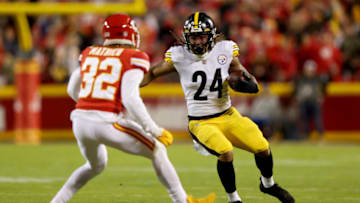 KANSAS CITY, MISSOURI - DECEMBER 26: Benny Snell #24 of the Pittsburgh Steelers runs the ball while Tyrann Mathieu #32 of the Kansas City Chiefs defends during the third quarter at Arrowhead Stadium on December 26, 2021 in Kansas City, Missouri. (Photo by Jamie Squire/Getty Images)