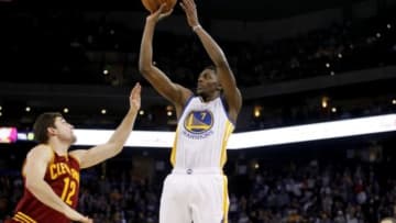 Jan 9, 2015; Oakland, CA, USA; Golden State Warriors guard Justin Holiday (7) attempts a shot over Cleveland Cavaliers guard Joe Harris (12) in the fourth quarter at Oracle Arena. The Warriors defeated the Cavaliers 112-94. Mandatory Credit: Cary Edmondson-USA TODAY Sports