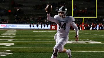 PISCATAWAY, NJ - NOVEMBER 25: Brian Lewerke #14 of the Michigan State Spartans runs in for a touchdown against the Rutgers Scarlet Knights during their game on November 25, 2017 in Piscataway, New Jersey. (Photo by Jeff Zelevansky/Getty Images)