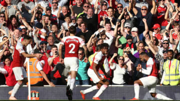 Arsenal's Mesut Ozil (left) celebrates with his team-mates after scoring his side's second goal of the game during the Premier League match at the Emirates Stadium, London. (Photo by Yui Mok/PA Images via Getty Images)
