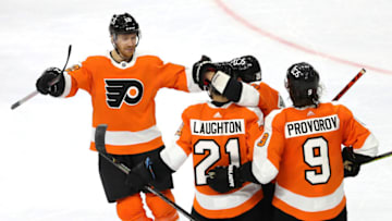 PHILADELPHIA, PENNSYLVANIA - JANUARY 30: Scott Laughton #21 of the Philadelphia Flyers is congratulated by teammates Michael Raffl #12,Claude Giroux #28 and Ivan Provorov #9 of the Philadelphia Flyers after Laughton scored the game winning goal in overtime against the New York Islanders at Wells Fargo Center on January 30, 2021 in Philadelphia, Pennsylvania.The Philadelphia Flyers defeated the New York Islanders 3-2 in overtime. (Photo by Elsa/Getty Images)