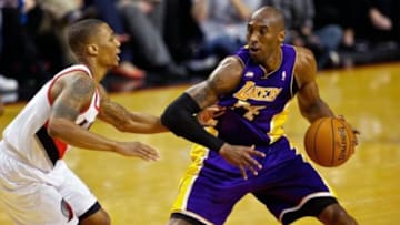 Apr 10, 2013; Portland, OR, USA; Los Angeles Lakers shooting guard Kobe Bryant (24) steps back from Portland Trail Blazers point guard Damian Lillard (0) at the Rose Garden. Mandatory Credit: Craig Mitchelldyer-USA TODAY Sports