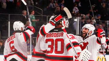 NEW YORK, NY - MAY 23: Martin Brodeur #30, Andy Greene #6 and Bryce Salvador #24 of the New Jersey Devils celebrate their 5 to 3 win over the New York Rangers in Game Five of the Eastern Conference Final during the 2012 NHL Stanley Cup Playoffs at Madison Square Garden on May 23, 2012 in New York City. (Photo by Paul Bereswill/Getty Images)