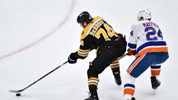 May 31, 2021; Boston, Massachusetts, USA; Boston Bruins left wing Jake DeBrusk (74) controls the puck while New York Islanders defenseman Scott Mayfield (24) defends during the second period in game two of the second round of the 2021 Stanley Cup Playoffs at TD Garden. Mandatory Credit: Bob DeChiara-USA TODAY Sports