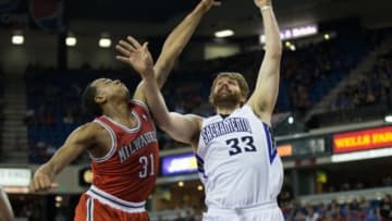 Mar 23, 2014; Sacramento, CA, USA; Sacramento Kings center Aaron Gray (33) scores a basket against Milwaukee Bucks center John Henson (31) during the fourth quarter at Sleep Train Arena. The Sacramento Kings defeated the Milwaukee Bucks 124-107. Mandatory Credit: Kelley L Cox-USA TODAY Sports