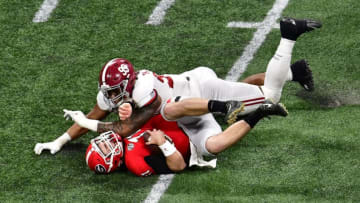 ATLANTA, GA - JANUARY 08: Jake Fromm #11 of the Georgia Bulldogs is sacked by Raekwon Davis #99 of the Alabama Crimson Tide in the CFP National Championship presented by AT&T at Mercedes-Benz Stadium on January 8, 2018 in Atlanta, Georgia. (Photo by Scott Cunningham/Getty Images)