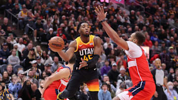 Dec 18, 2021; Salt Lake City, Utah, USA; Utah Jazz guard Donovan Mitchell (45) passes a ball around Washington Wizards center Daniel Gafford (21) in the fourth quarter at Vivint Arena. Mandatory Credit: Rob Gray-USA TODAY Sports