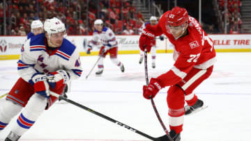 DETROIT, MI - DECEMBER 29: Andreas Athanasiou #72 of the Detroit Red Wings takes a second period shot next to Brendan Smith #42 of the New York Rangers at Little Caesars Arena on December 29, 2017 in Detroit, Michigan. (Photo by Gregory Shamus/Getty Images)
