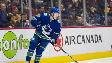 Apr 12, 2022; Vancouver, British Columbia, CAN; Vancouver Canucks defenseman Quinn Hughes (43) handles the puck against the Vegas Golden Knights in the second period at Rogers Arena. Mandatory Credit: Bob Frid-USA TODAY Sports