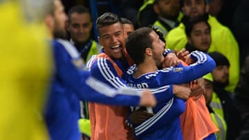 Chelsea's Belgian midfielder Eden Hazard (R) celebrates scoring the 2-2 equalising goal during the English Premier League football match between Chelsea and Tottenham Hotspur at Stamford Bridge in London on May 2, 2016. / AFP / GLYN KIRK / RESTRICTED TO EDITORIAL USE. No use with unauthorized audio, video, data, fixture lists, club/league logos or 'live' services. Online in-match use limited to 75 images, no video emulation. No use in betting, games or single club/league/player publications. / (Photo credit should read GLYN KIRK/AFP/Getty Images)