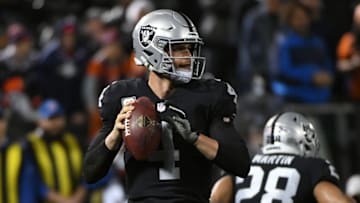 OAKLAND, CA - DECEMBER 24: Derek Carr #4 of the Oakland Raiders looks to pass against the Denver Broncos during their NFL game at Oakland-Alameda County Coliseum on December 24, 2018 in Oakland, California. (Photo by Robert Reiners/Getty Images)