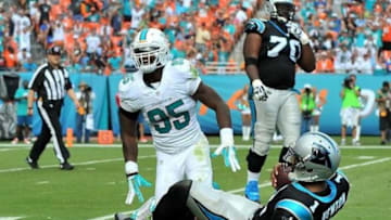 Nov 24, 2013; Miami Gardens, FL, USA; Miami Dolphins defensive end Dion Jordan (95) reacts after sacking Carolina Panthers quarterback Cam Newton (1) during the second quarter at Sun Life Stadium. Mandatory Credit: Steve Mitchell-USA TODAY Sports