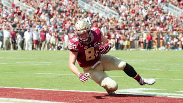 TALLAHASSEE, FL - OCTOBER 21: Tight end Ryan Izzo #81 of the Florida State Seminoles catches a pass in the enzone for a touchdown during their game against the Louisville Cardinals at Doak Campbell Stadium on October 21, 2017 in Tallahassee, Florida. (Photo by Michael Chang/Getty Images)