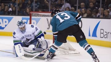 September 29, 2015; San Jose, CA, USA; Vancouver Canucks goalie Ryan Miller (30) makes a save against San Jose Sharks left wing Raffi Torres (13) during the second period at SAP Center at San Jose. Mandatory Credit: Kyle Terada-USA TODAY Sports