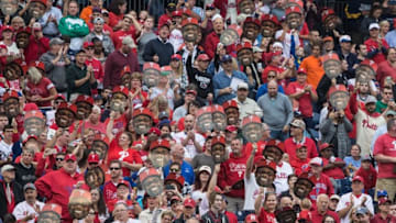 Oct 2, 2016; Philadelphia, PA, USA; Fans wave Philadelphia Phillies first baseman Ryan Howard (6) heads on a stick during the second inning against the New York Mets at Citizens Bank Park. Mandatory Credit: Bill Streicher-USA TODAY Sports