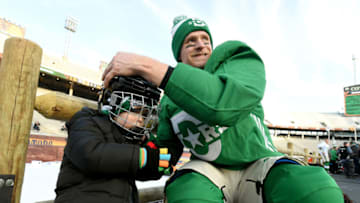 DALLAS, TEXAS - DECEMBER 31: Corey Perry #10 of the Dallas Stars puts a helmet on his son's head during family skate ahead of the 2020 Bridgestone NHL Winter Classic at Cotton Bowl on December 31, 2019 in Dallas, Texas. (Photo by Brian Babineau/NHLI via Getty Images)