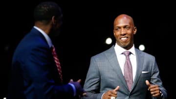 Feb 10, 2016; Auburn Hills, MI, USA; Retired professional basketball player Chauncey Billups smiles at Isiah Thomas as he walks onto the court during halftime in the game between the Detroit Pistons and the Denver Nuggets at The Palace of Auburn Hills. Nuggets win 103-92. Mandatory Credit: Raj Mehta-USA TODAY Sports