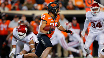 STILLWATER, OK - NOVEMBER 30: Running back Chuba Hubbard #30 of the Oklahoma State Cowboys looks for an opening against the Oklahoma Sooners in the fourth quarter on November 30, 2019 at Boone Pickens Stadium in Stillwater, Oklahoma. OU won 34-16. (Photo by Brian Bahr/Getty Images)