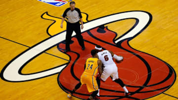 MIAMI, FL - MAY 30: LeBron James #6 of the Miami Heat brings the ball up the floor as Paul George #24 of the Indiana Pacers defends during Game Six of the Eastern Conference Finals of the 2014 NBA Playoffs at American Airlines Arena on May 30, 2014 in Miami, Florida. NOTE TO USER: User expressly acknowledges and agrees that, by downloading and or using this photograph, User is consenting to the terms and conditions of the Getty Images License Agreement. (Photo by Chris Trotman/Getty Images)