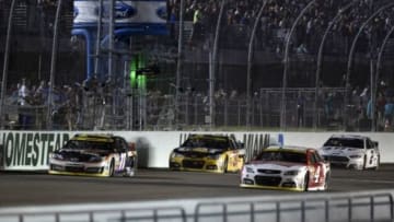Nov 16, 2014; Homestead, FL, USA; NASCAR Sprint Cup Series driver Kevin Harvick (4) passes Denny Hamlin (11) ahead of Ryan Newman (31) and Brad Keselowski (2) during the Ford EcoBoost 400 at Homestead-Miami Speedway. Mandatory Credit: Jerome Miron-USA TODAY Sports