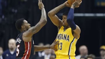 Apr 5, 2015; Indianapolis, IN, USA; Indiana Pacers forward Paul George (13) is guarded by Miami Heat guard Mario Chalmers (15) in the first quarter at Bankers Life Fieldhouse. Mandatory Credit: Brian Spurlock-USA TODAY Sports