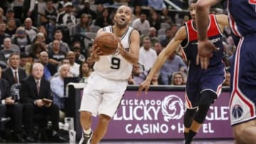 Dec 16, 2015; San Antonio, TX, USA; San Antonio Spurs point guard Tony Parker (9) drives to the basket past Washington Wizards small forward Otto Porter Jr. (right) during the first half at AT&T Center. Mandatory Credit: Soobum Im-USA TODAY Sports
