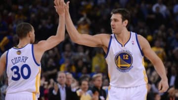 December 11, 2013; Oakland, CA, USA; Golden State Warriors center Andrew Bogut (12) celebrates with point guard Stephen Curry (30) during the fourth quarter against the Dallas Mavericks at Oracle Arena. The Warriors defeated the Mavericks 95-93. Mandatory Credit: Kyle Terada-USA TODAY Sports