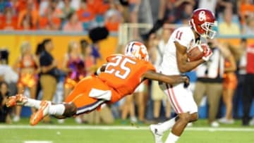 Dec 31, 2015; Miami Gardens, FL, USA; Oklahoma Sooners wide receiver Dede Westbrook (11) makes a reception against Clemson Tigers cornerback Cordrea Tankersley (25) during the second quarter of the 2015 CFP semifinal at the Orange Bowl at Sun Life Stadium. Mandatory Credit: Robert Duyos-USA TODAY Sports