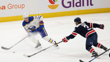 Apr 15, 2021; Washington, District of Columbia, USA; Buffalo Sabres center Dylan Cozens (24) skates with the puck as Washington Capitals defenseman Nick Jensen (3) defends in the third period at Capital One Arena. Mandatory Credit: Geoff Burke-USA TODAY Sports