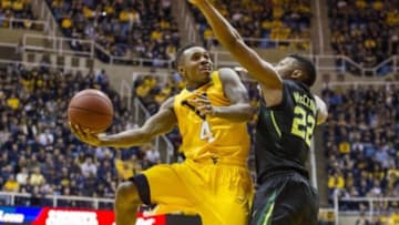 Feb 6, 2016; Morgantown, WV, USA; West Virginia Mountaineers guard Daxter Miles Jr. (4) shoots over Baylor Bears guard King McClure (22) during the second half at the WVU Coliseum. Mandatory Credit: Ben Queen-USA TODAY Sports