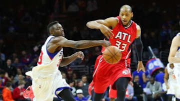 Jan 13, 2015; Philadelphia, PA, USA; Philadelphia 76ers forward Jerami Grant (39) and Atlanta Hawks forward Adreian Payne (33) battle for a loose ball during the second half at Wells Fargo Center. The Hawks defeated the 76ers 105-87. Mandatory Credit: Bill Streicher-USA TODAY Sports