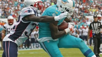 Jan 3, 2016; Miami Gardens, FL, USA; New England Patriots defensive back Devin McCourty (32) moves in as Miami Dolphins wide receiver DeVante Parker (11) makes a catch this second quarter touchdown at Sun Life Stadium. Mandatory Credit: Andrew Innerarity-USA TODAY Sports